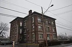 Apartment house on Milne Street, in Sterling Hill, settled by Irish emigres. Three deckers, brick tenements and small houses are found here.