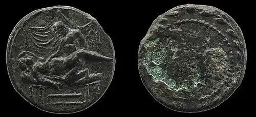 Female-male sex on a bed, likely with a numeral on the corroded reverse