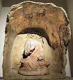 Buddha with flying Erotes holding a wreath overhead, Tapa Kalan, 3rd century CE