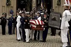 Honor guards carry the casket of former President Ronald Reagan to a waiting hearse outside of Washington National Cathedral.