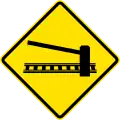 PI-1b Railway crossing ahead with gates or barriers