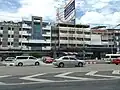 Brutalist shophouses beside a contemporary office block in Chatuchak District, Bangkok