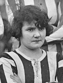 Carmen Pomiès, a white French woman with dark hair, in a striped shirt with arms crossed