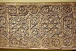 Carved stucco panel from the city of Samarra. Floral pattern with Abbasid geometric designs, grapes, vines, and ears of pine cones. third Islamic century AH (9th century)