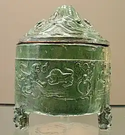 A Han celadon pot with mountain-shaped lid and animal designs