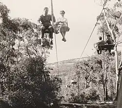 View of a chairlift from below with chairs passing up and down