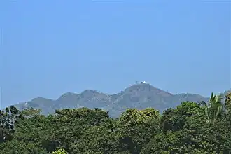 Chandranath Hill, as seen from the Dhaka-Chittagong railroad. It is the tallest peak in Chittagong district, and is the location of Chandranath and Birupakkha temples.