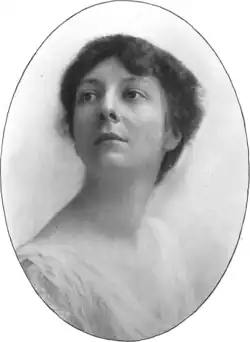 A white woman with dark hair, in an oval frame