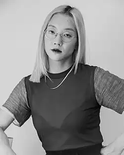 Black and white portrait of a blonde woman wearing glasses