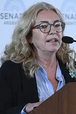 Claudia Rucci speaks at a lectern