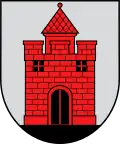 A coat of arms depicting a red castle with black double doors, two black windows, and one central tower all standing on black ground