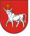 A coat of arms depicting a white bull with an angry expression and a golden cross protruding from its head all on a red background