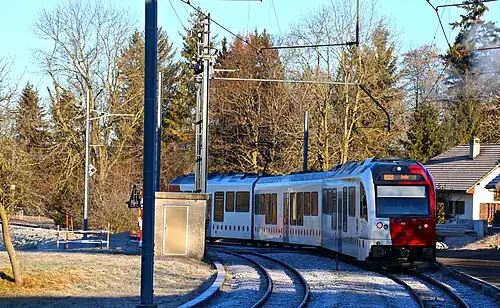 Passing loop track with a train next to a platform