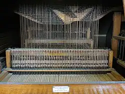 Interior of the organ at Cradley Heath Baptist Church showing the tracker action. The black rods, called rollers, rotate to transmit movement sideways to line up with the pipes.