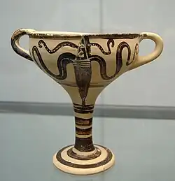Goblet-shaped ceramic vessel, with a tall stem and two handles, painted in black with a squid design