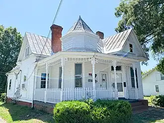 North Danville two-story 1895 frame home built with other identical homes. It has a two-story full-width porch and dual entrances.