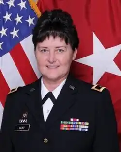 Image of Darlene Goff in uniform in front of an American flag, professional portrait
