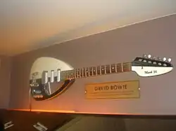 A guitar hanging on a wall