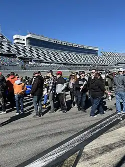Auto-racing track with a large grandstand filled with spectators