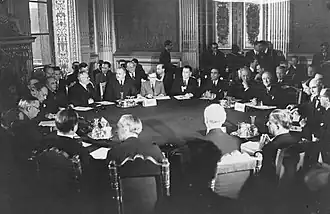 Men in suits sitting around a circular table