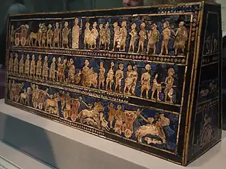 Standard of Ur; 2600–2400 BC; shell, red limestone and lapis lazuli on wood; length: 49.5&nbsp;cm; from the Royal Cemetery at Ur; British Museum