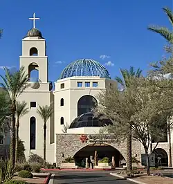 A building in Mission Revival style with a prominent ornamental dorm and a campanile-type tower