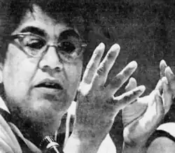 Portrait of a woman in glasses gesturing with her hands