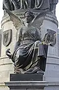 One of the four winged figures at the base of the monument