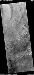 Twisted bands on the floor of Hellas Planitia, as seen by HiRISE under HiWish program These twisted bands are also called "taffy pull" terrain.
