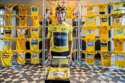 Egan Bernal in 2019, in front of an assortment yellow jerseys of the museum.