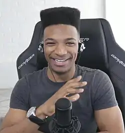 Amofah pictured in May 2019 sitting in a gaming chair, looking and smiling at the camera