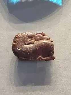 Etruscan amber pendant of a lion and a swan