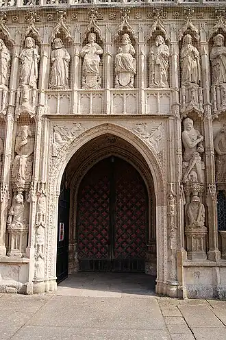 An arched doorway surrounded by tiers of carved figures