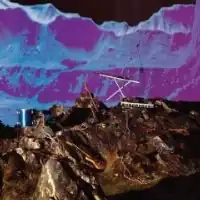 A collage with a blue-tinted mountain range in the background and a brown/grey rocky landscape containing a guitar, a drum, two keyboards, and lengths of electrical wire in the foreground.