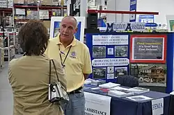 A mitigation advisor speaks to a woman at a Sam's Club store in Bismarck, North Dakota, United States