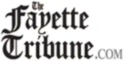 Consists of "The Fayette Tribune" in a black Gothic font and ".com" in a gray modern font