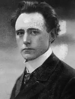 Black and white photograph of a man wearing a suit and tie