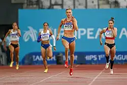Photo of Femke Bol sprinting while ahead three other competitors