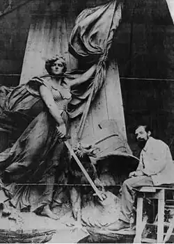 Photograph of Fernand Hamar working on the statue