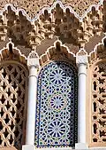 Decorative niches with zellij and carved muqarnas above the gates