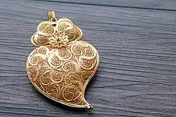 Image 39Typical Portuguese filigree heart shaped pendant, an iconic item in Portuguese fashion and design. (from Culture of Portugal)