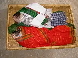 The groom's family members often bring fish decorated as a wedding couple to the bride's gaye holud