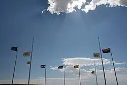 The flag of Colorado (third pole from left) alongside others at the Four Corners Monument