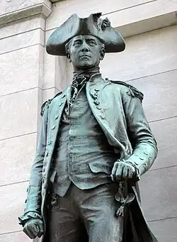 A bronze statue of a man in naval uniform