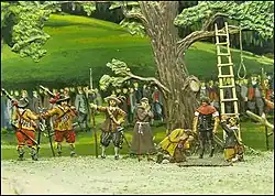 The Frankburger Würfelspiel has forced each two men to play for their life throwing the dice below the rope hanging from the tree that would be used to immediately hang the one who loses – a priest is nearby for a last prayer and a line of Bavarian soldiers guard the scene from the large mass in the background