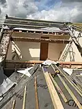 Dormer extension with tiles and felt stripped off and wood battens removed