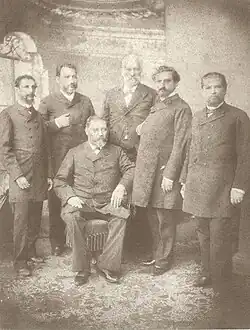 A picture of the 6 members of Caballero's cabinet; Caballero, the president, is sitting down at the center.