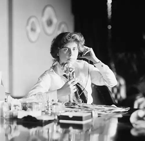 An American candlestick telephone being used by Genevieve Clark Thomson, circa 1915.