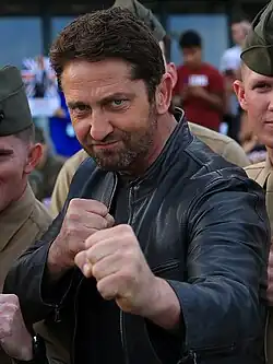 Gerard Butler posing with a group of Marines at Camp Pendleton in 2016