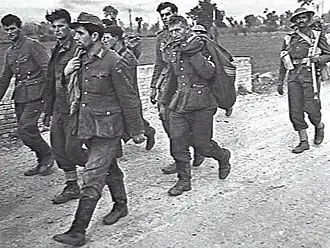 Indian soldier escorts German prisoners after Battle of the Sangro